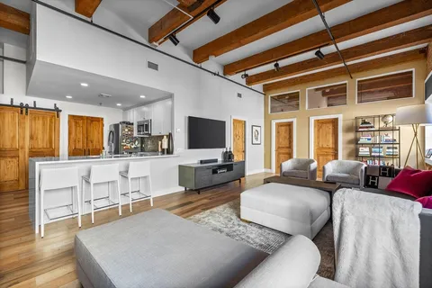 a living room with furniture flat screen tv and window