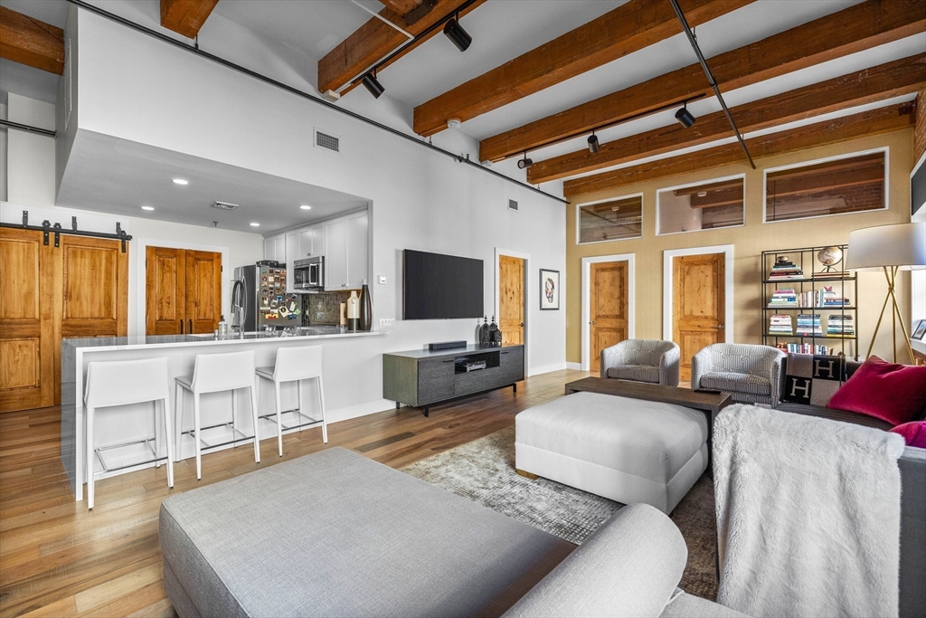 15 Sleeper Street, Unit 206 Boston, MA 02210 - Photo 3 of 21 a living room with furniture flat screen tv and window