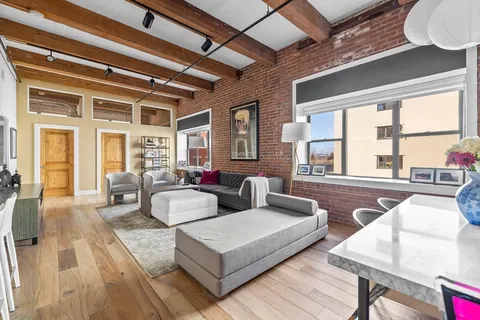 a living room with furniture and large windows