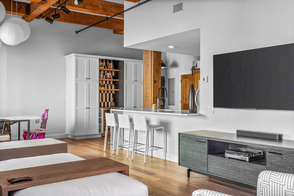 15 Sleeper Street, Unit 206 Boston, MA 02210 - Photo 6 of 21 a living room with furniture and a flat screen tv