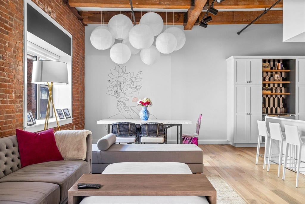 15 Sleeper Street, Unit 206 Boston, MA 02210 - Photo 9 of 21 a living room with furniture and a large window