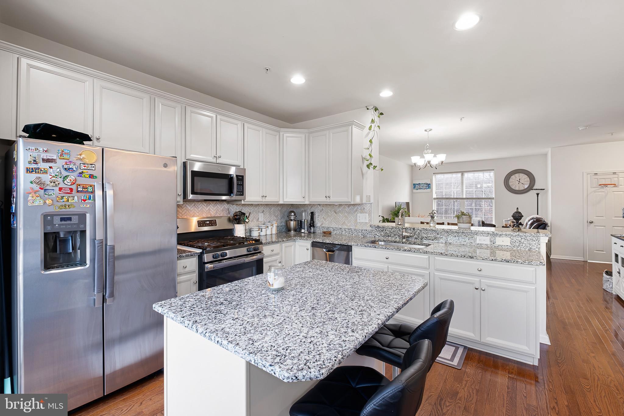 453 Lenape Way Claymont, DE 19703 - Photo 15 of 20 a kitchen with granite countertop kitchen island wooden cabinets and stainless steel appliances