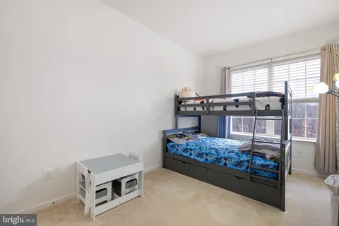 a bed room with a bed and a window