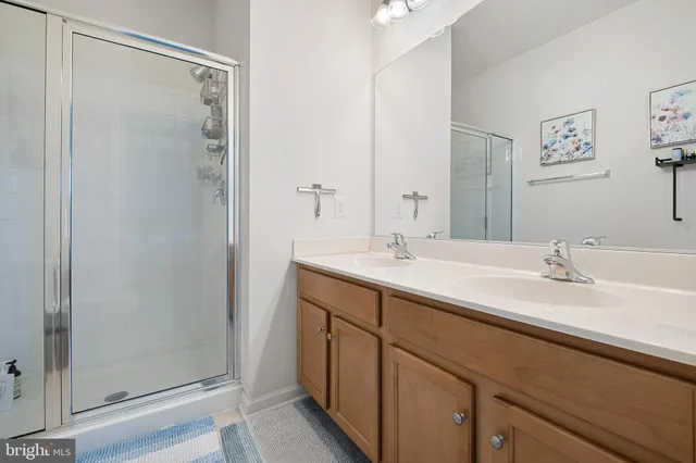 a bathroom with a double vanity sink mirror and