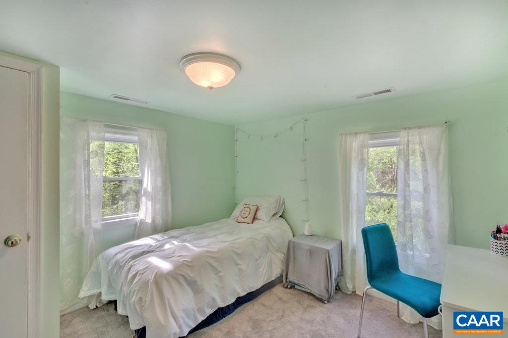 2908 Precinct Road Esmont, VA 22937 - Photo 14 of 23 a bedroom with a bed and a chair