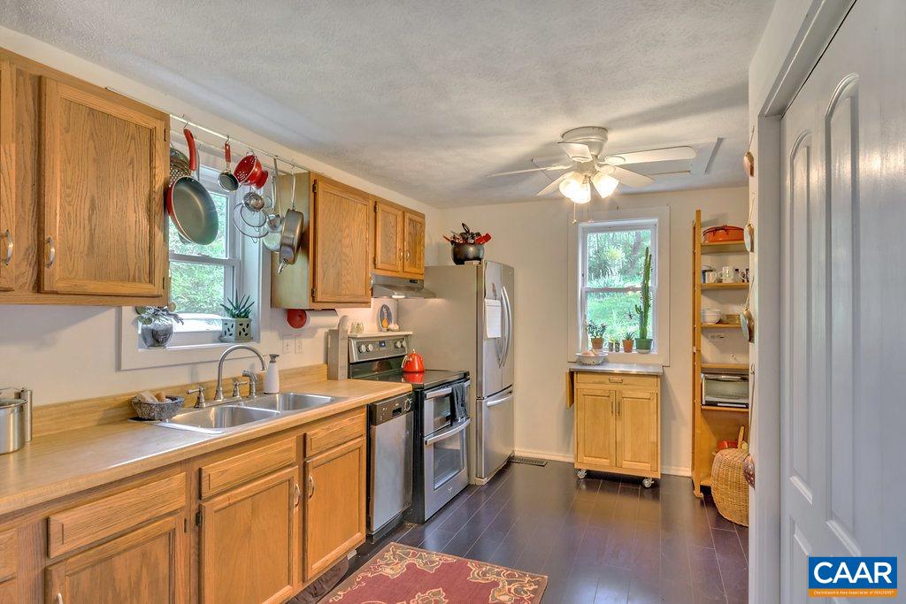 2908 Precinct Road Esmont, VA 22937 - Photo 4 of 23 a kitchen with stainless steel appliances a stove a sink dishwasher and a refrigerator with wooden floor