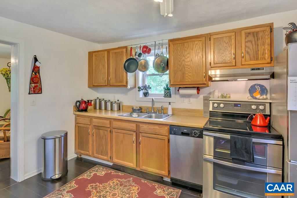 2908 Precinct Road Esmont, VA 22937 - Photo 5 of 23 a kitchen with stainless steel appliances granite countertop a stove a sink and a microwave