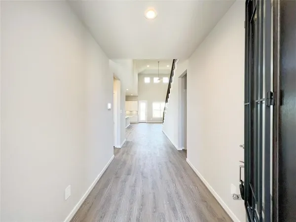 a view of a hallway with wooden floor