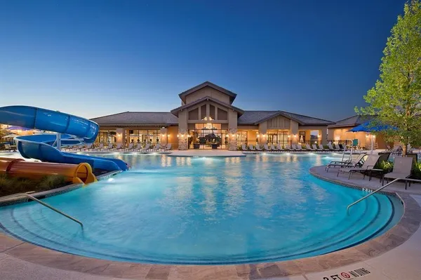 a view of a swimming pool and an outdoor seating