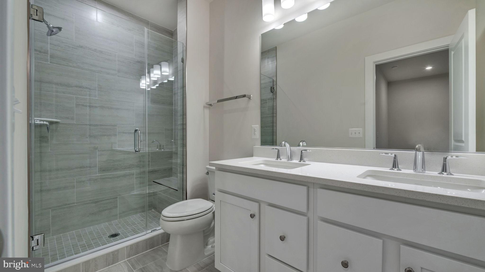 13170 Arches Road Herndon, VA 20170 - Photo 11 of 30 a bathroom with a granite countertop sink a toilet and shower