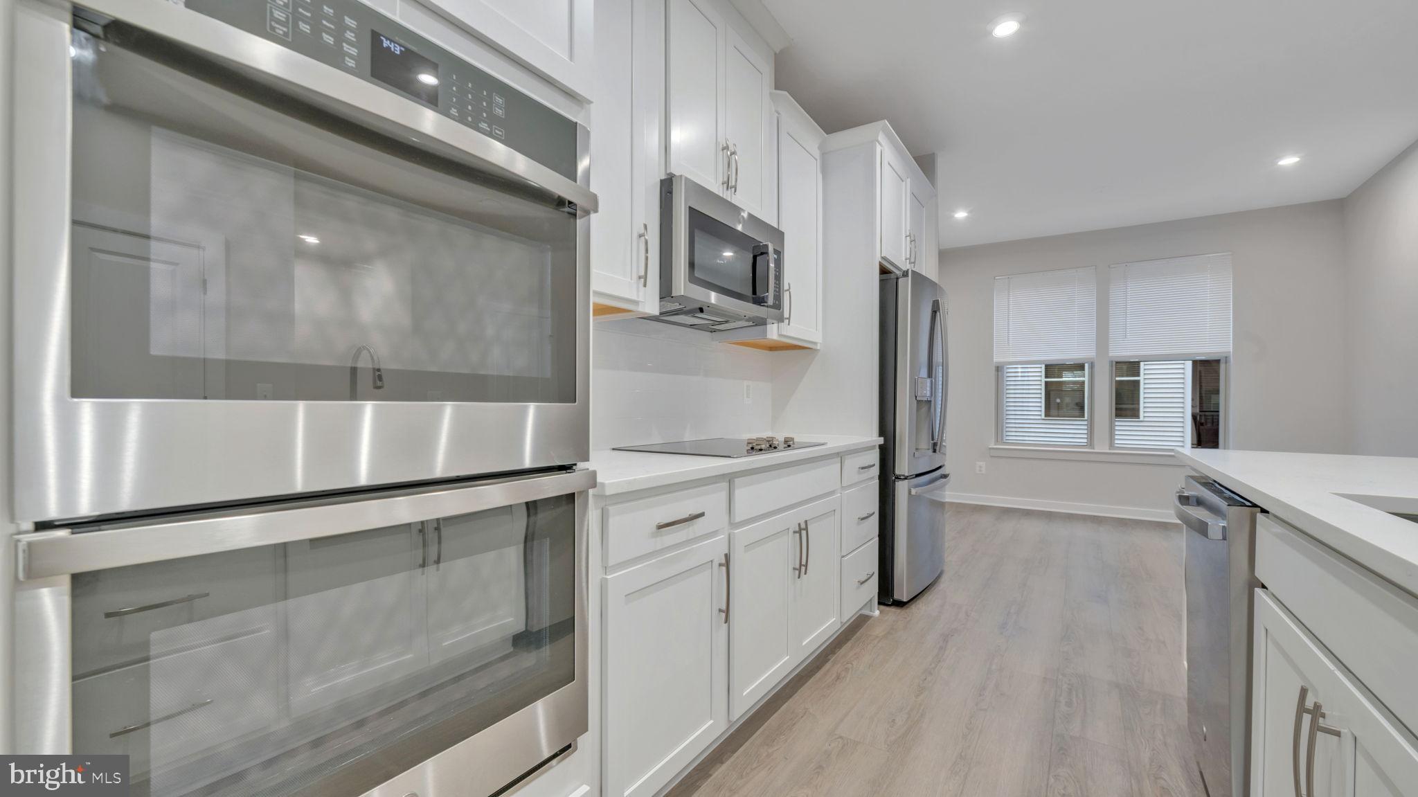 13170 Arches Road Herndon, VA 20170 - Photo 17 of 30 a kitchen with stainless steel appliances granite countertop a stove and a refrigerator