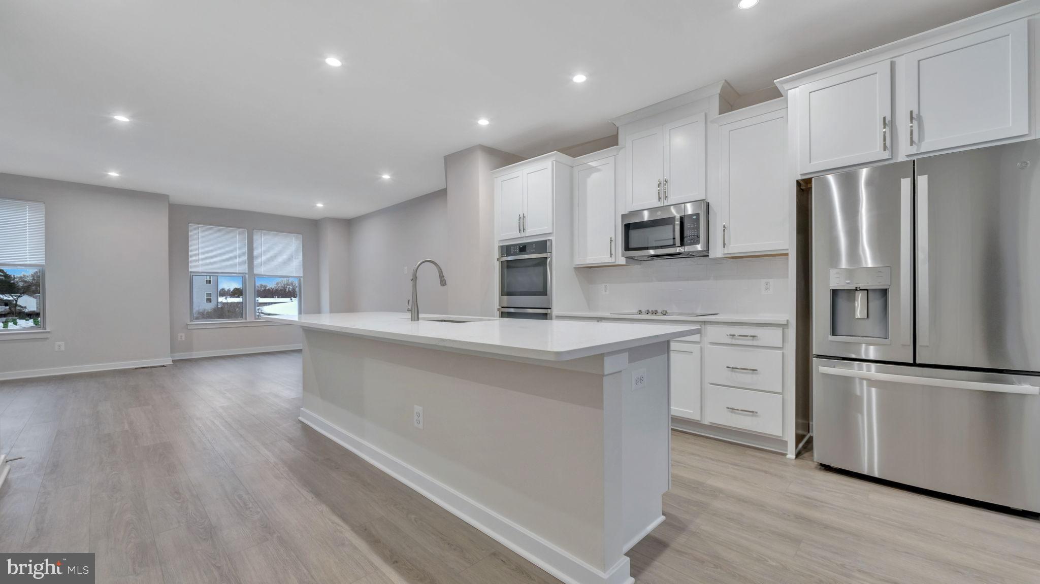 13170 Arches Road Herndon, VA 20170 - Photo 19 of 30 a large kitchen with stainless steel appliances a refrigerator and a stove top oven