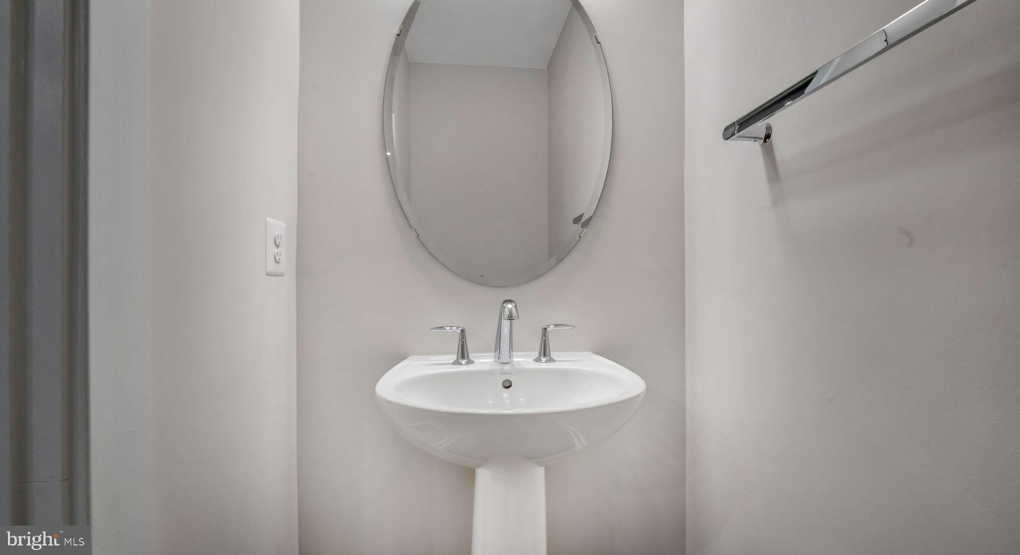 13170 Arches Road Herndon, VA 20170 - Photo 23 of 30 a bathroom with a sink and a mirror
