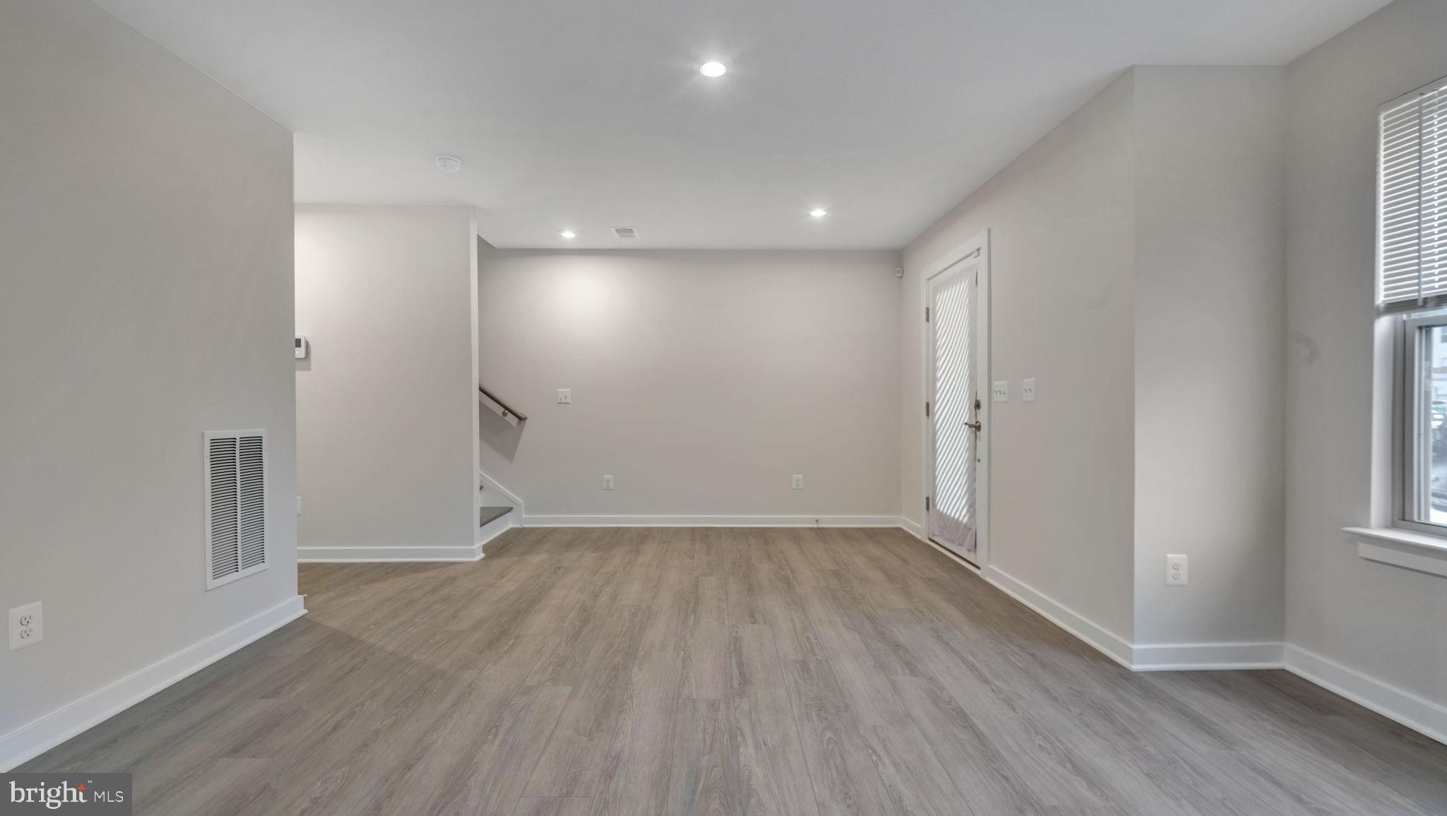 13170 Arches Road Herndon, VA 20170 - Photo 27 of 30 an empty room with wooden floor and windows