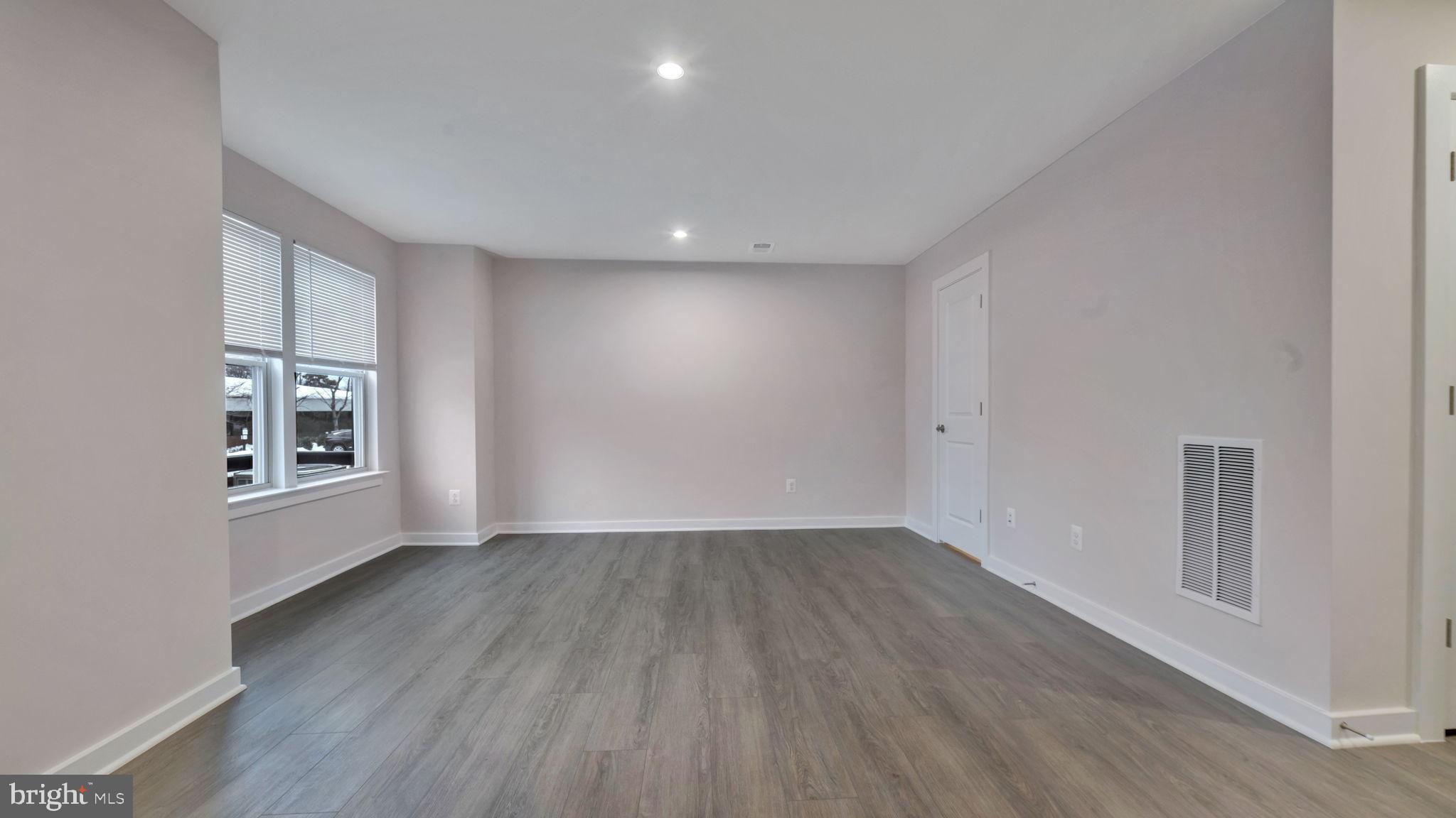 13170 Arches Road Herndon, VA 20170 - Photo 28 of 30 an empty room with wooden floor and windows