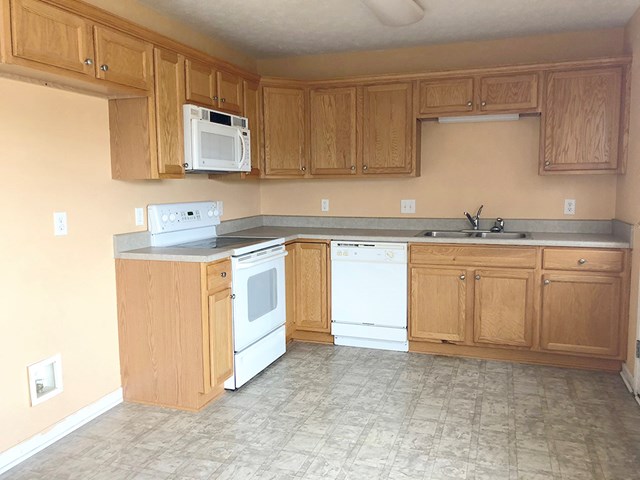 10 Alexander Loop Phenix City, AL 36869 - Photo 5 of 15 a kitchen with white cabinets sink and stove