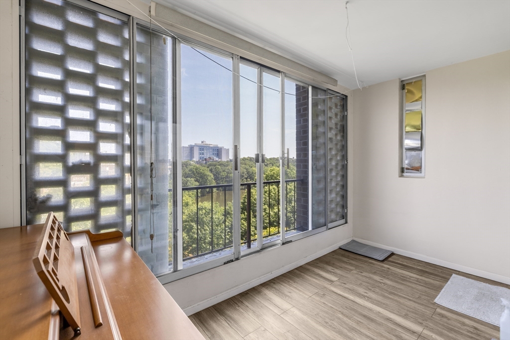 33 Pond Avenue, Unit 919 Brookline, MA 02445 - Photo 11 of 37 a view of a room with wooden floor and windows