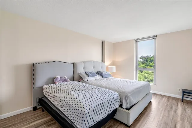 a bedroom with a bed and a lamp on table