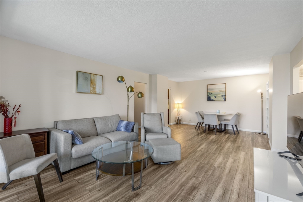 33 Pond Avenue, Unit 919 Brookline, MA 02445 - Photo 6 of 37 a living room with furniture and a flat screen tv