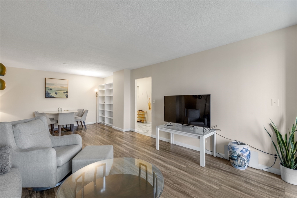 33 Pond Avenue, Unit 919 Brookline, MA 02445 - Photo 7 of 37 a living room with furniture and a flat screen tv