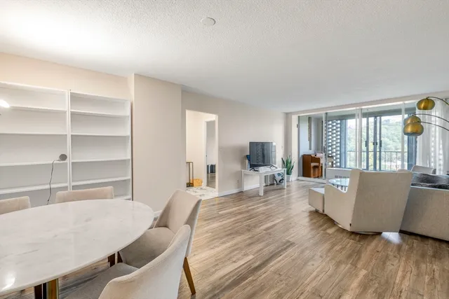 a view of a room with wooden floor and windows