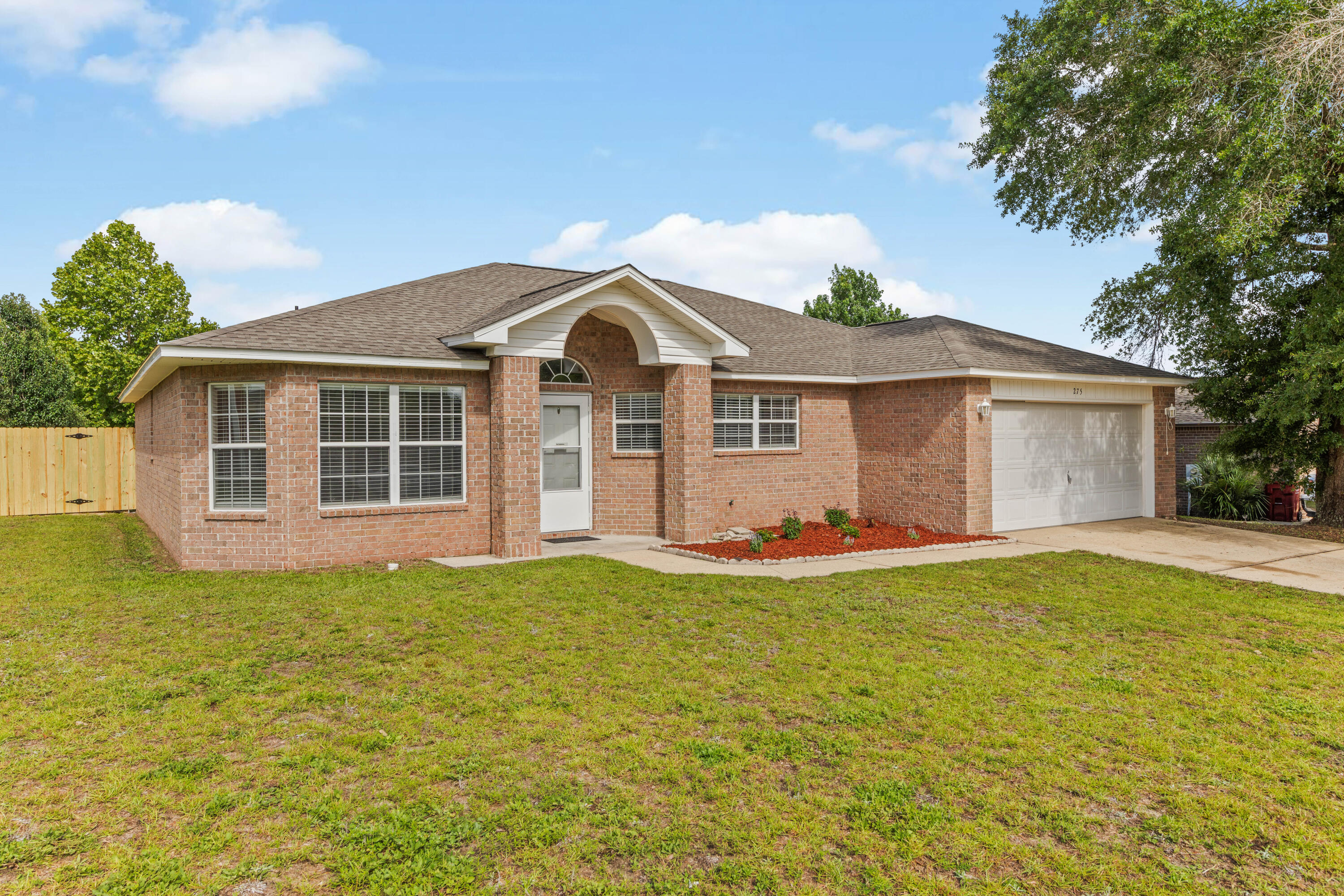 275 Limestone Circle Crestview, FL 32539 - Photo 1 of 45 a front view of a house with a garden and yard