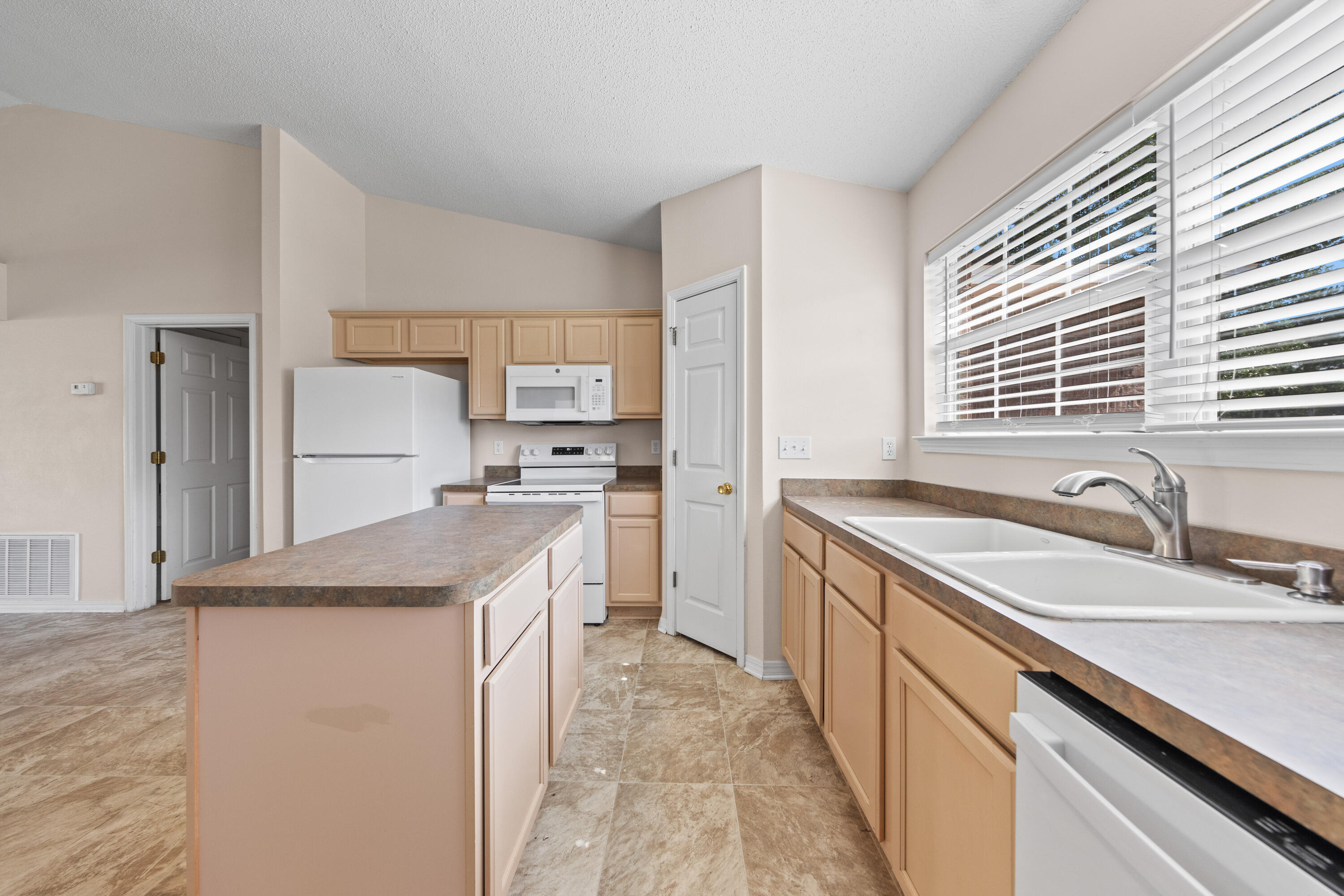 275 Limestone Circle Crestview, FL 32539 - Photo 12 of 45 a kitchen with a sink stove and refrigerator