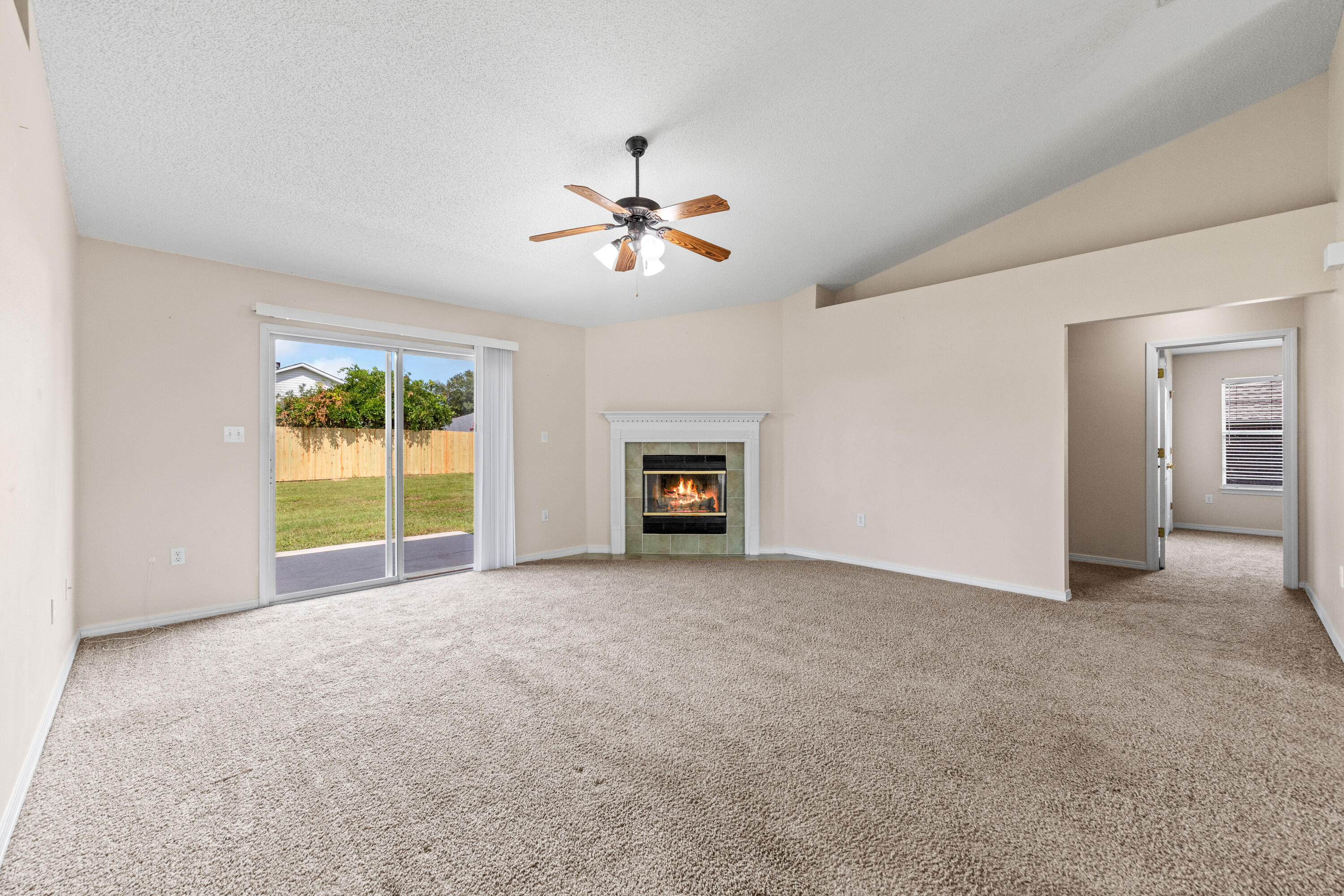 275 Limestone Circle Crestview, FL 32539 - Photo 16 of 45 a view of empty room with fireplace and fan