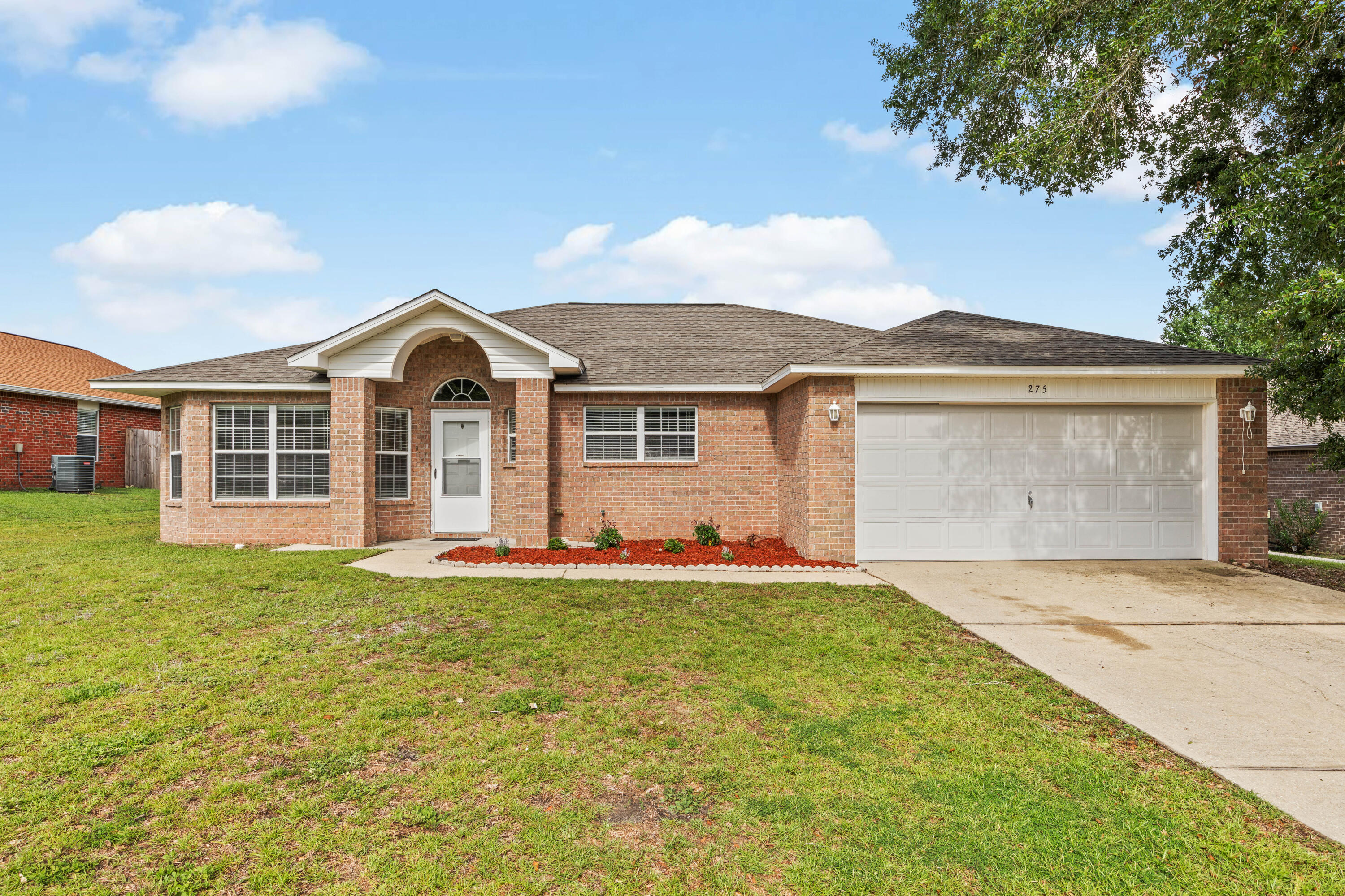 275 Limestone Circle Crestview, FL 32539 - Photo 2 of 45 a front view of a house with a yard and garage
