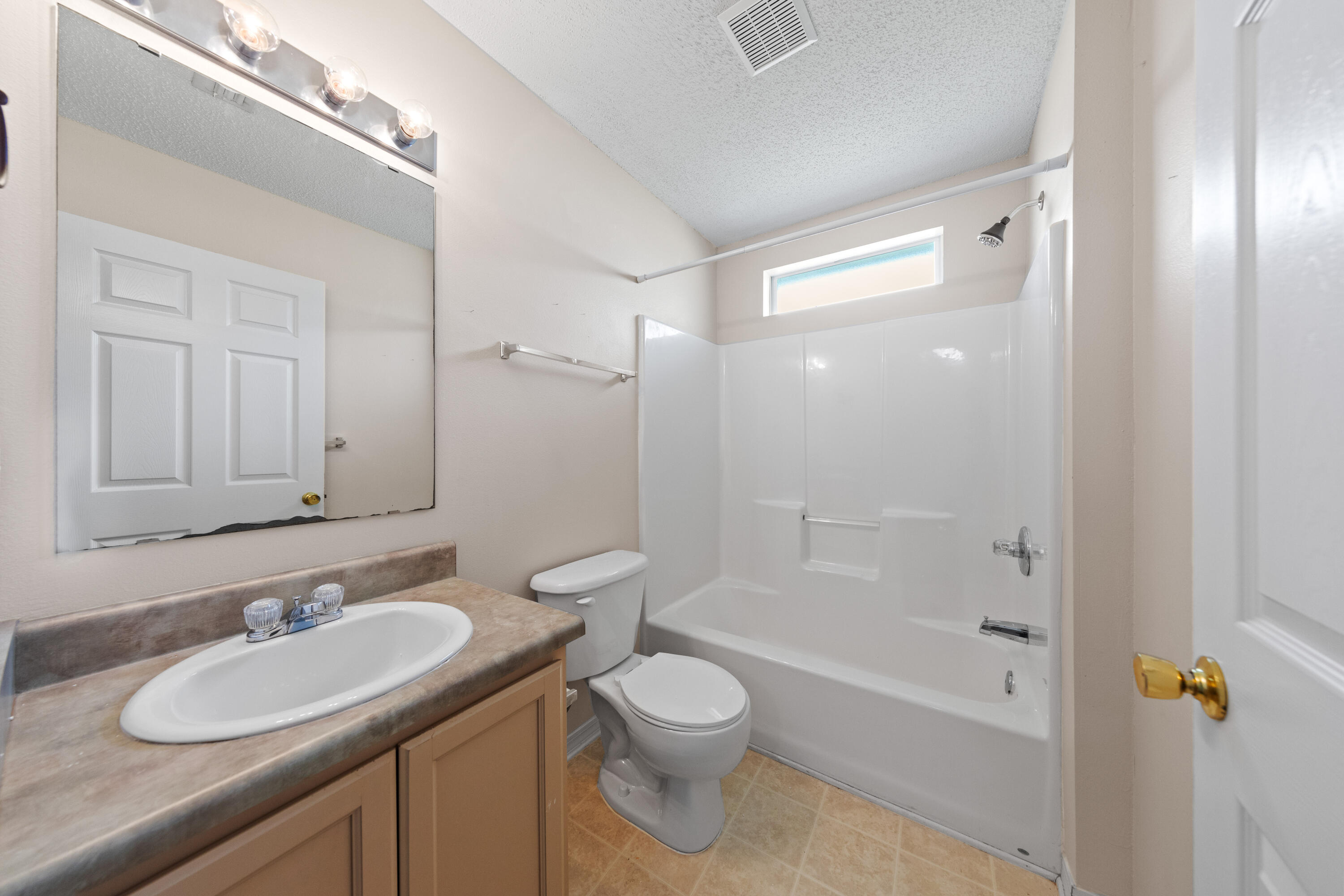 275 Limestone Circle Crestview, FL 32539 - Photo 27 of 45 a bathroom with a granite countertop sink toilet a mirror and shower