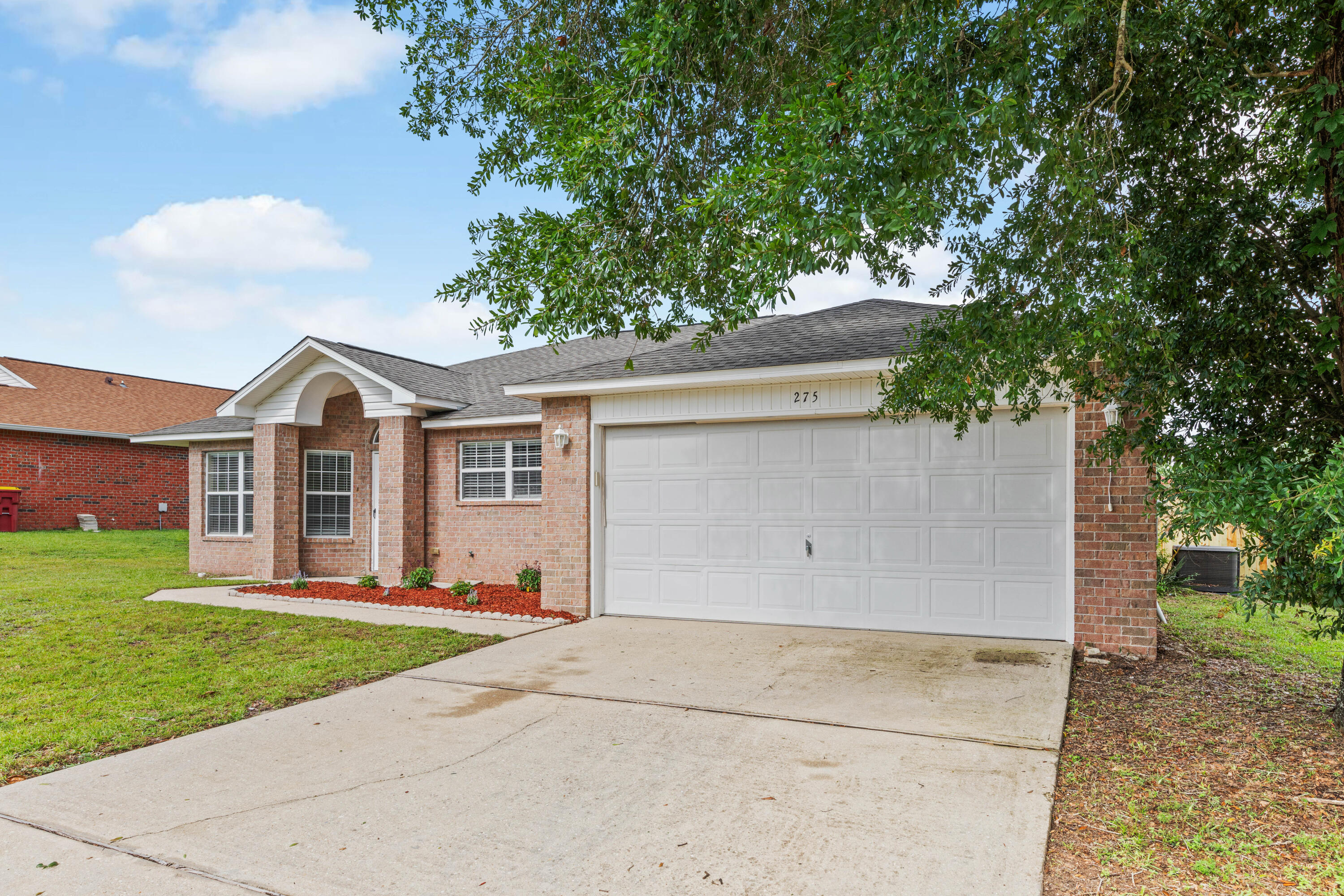 275 Limestone Circle Crestview, FL 32539 - Photo 3 of 45 a view of a house with a yard and large tree