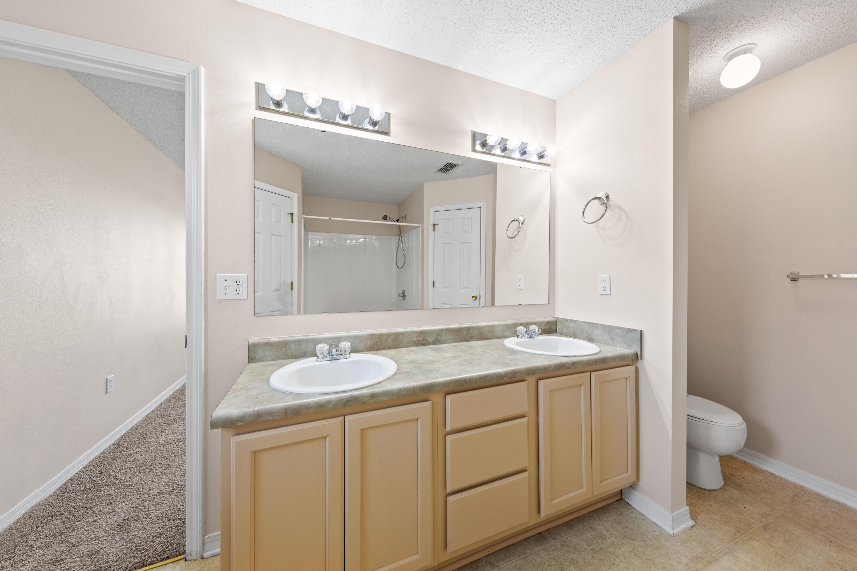 275 Limestone Circle Crestview, FL 32539 - Photo 38 of 45 a bathroom with a granite countertop sink a toilet and mirror