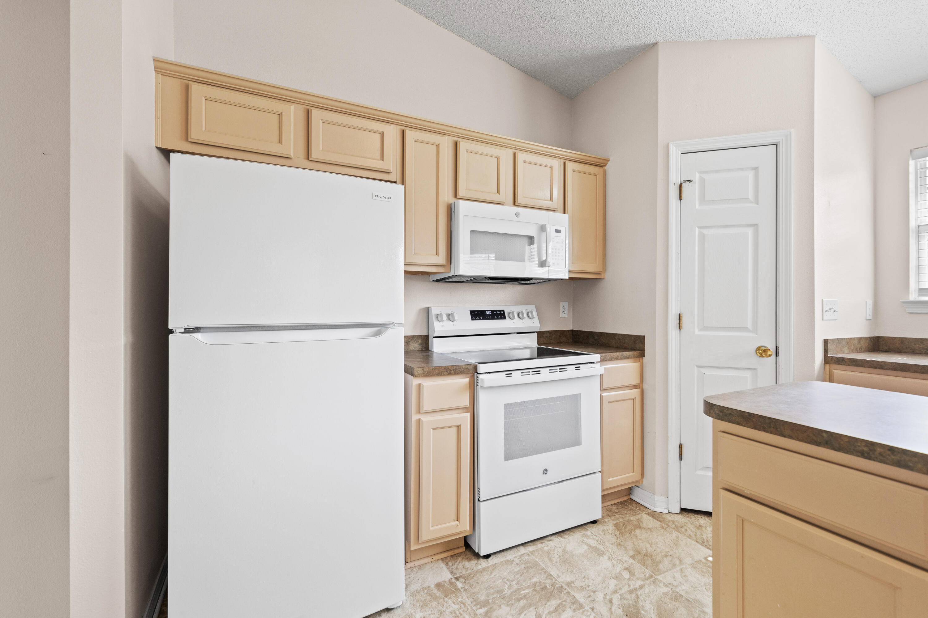 275 Limestone Circle Crestview, FL 32539 - Photo 9 of 45 a kitchen with a refrigerator sink stove and cabinets