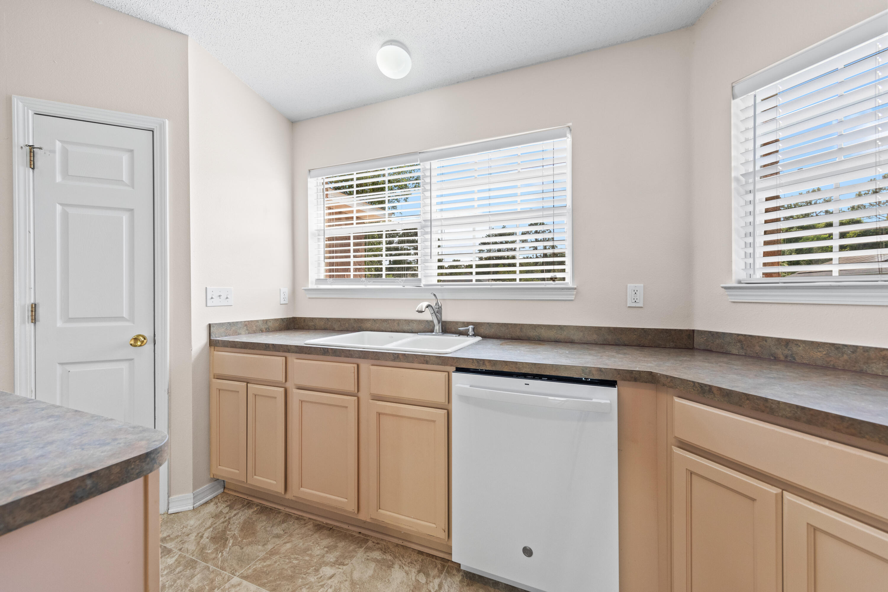 275 Limestone Circle Crestview, FL 32539 - Photo 10 of 45 a kitchen with granite countertop a sink and a white wooden cabinets