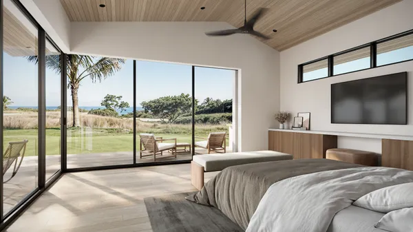 a bedroom with a large bed and a flat tv screen on dresser