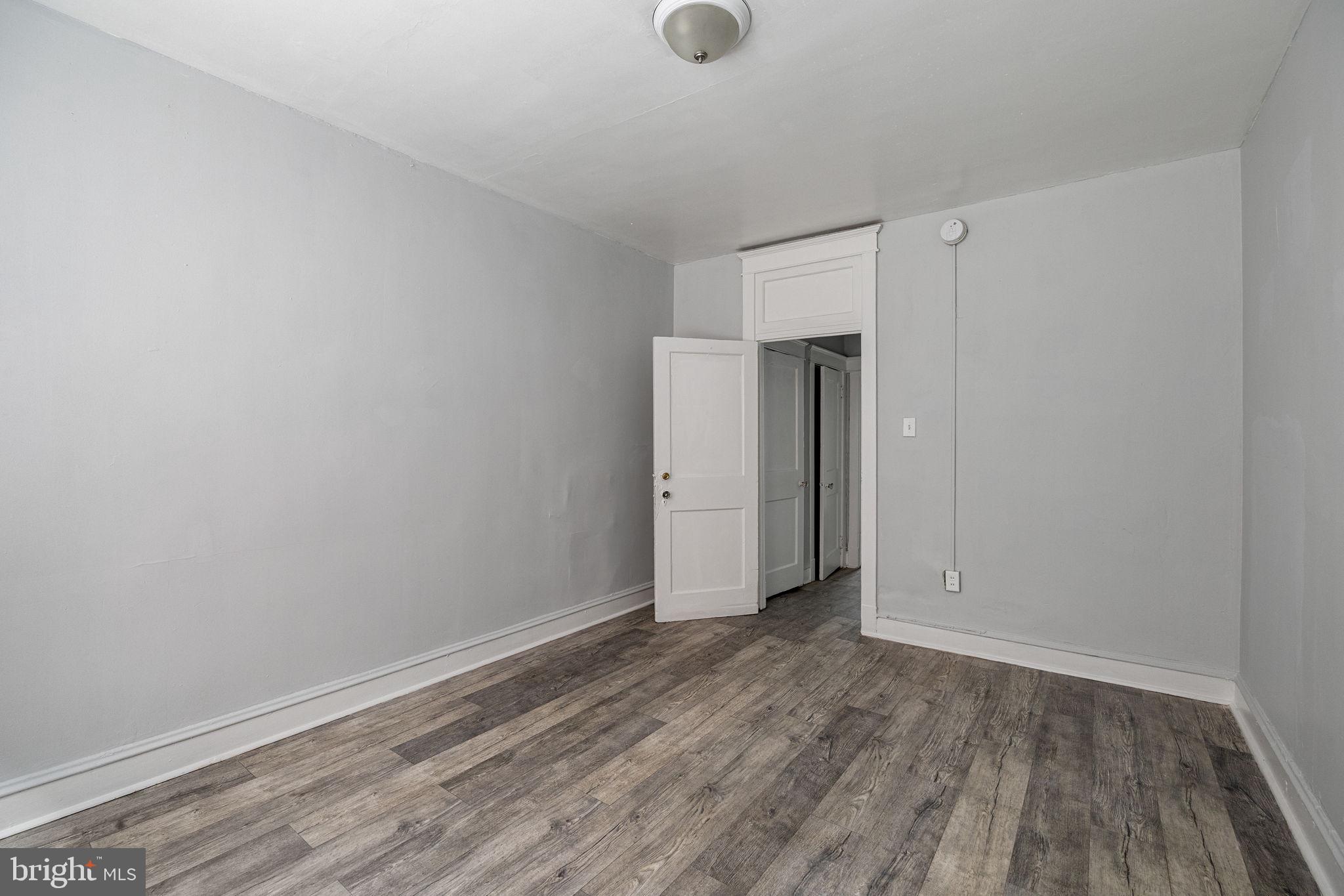 0 Garrett Road, Unit E101 Upper Darby, PA 19082 - Photo 14 of 19 a view of an empty room with wooden floor and closet