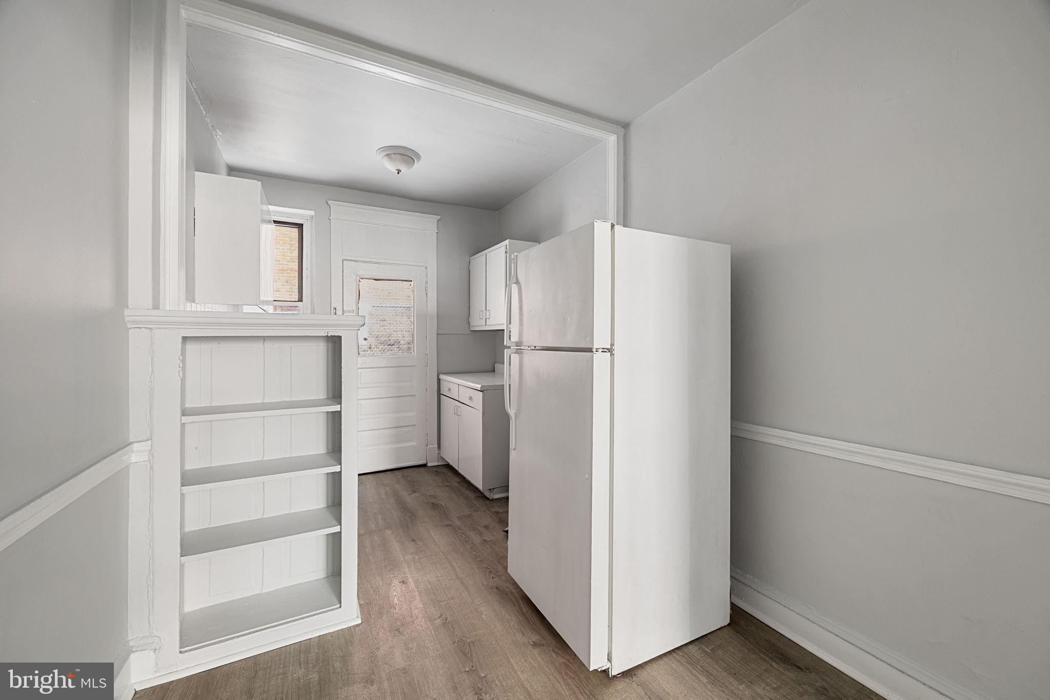 0 Garrett Road, Unit E101 Upper Darby, PA 19082 - Photo 10 of 19 a white refrigerator freezer and a stove sitting inside of a kitchen