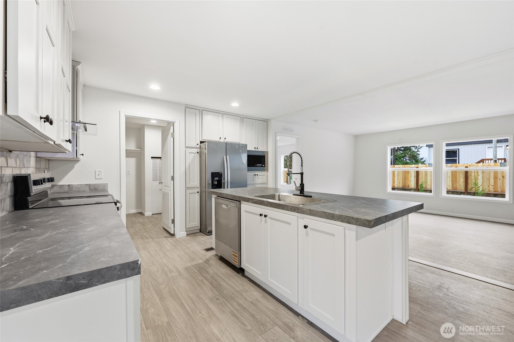 30 Porter Creek Road Elma, WA 98541 - Photo 11 of 33 a kitchen with stainless steel appliances granite countertop a sink and a refrigerator