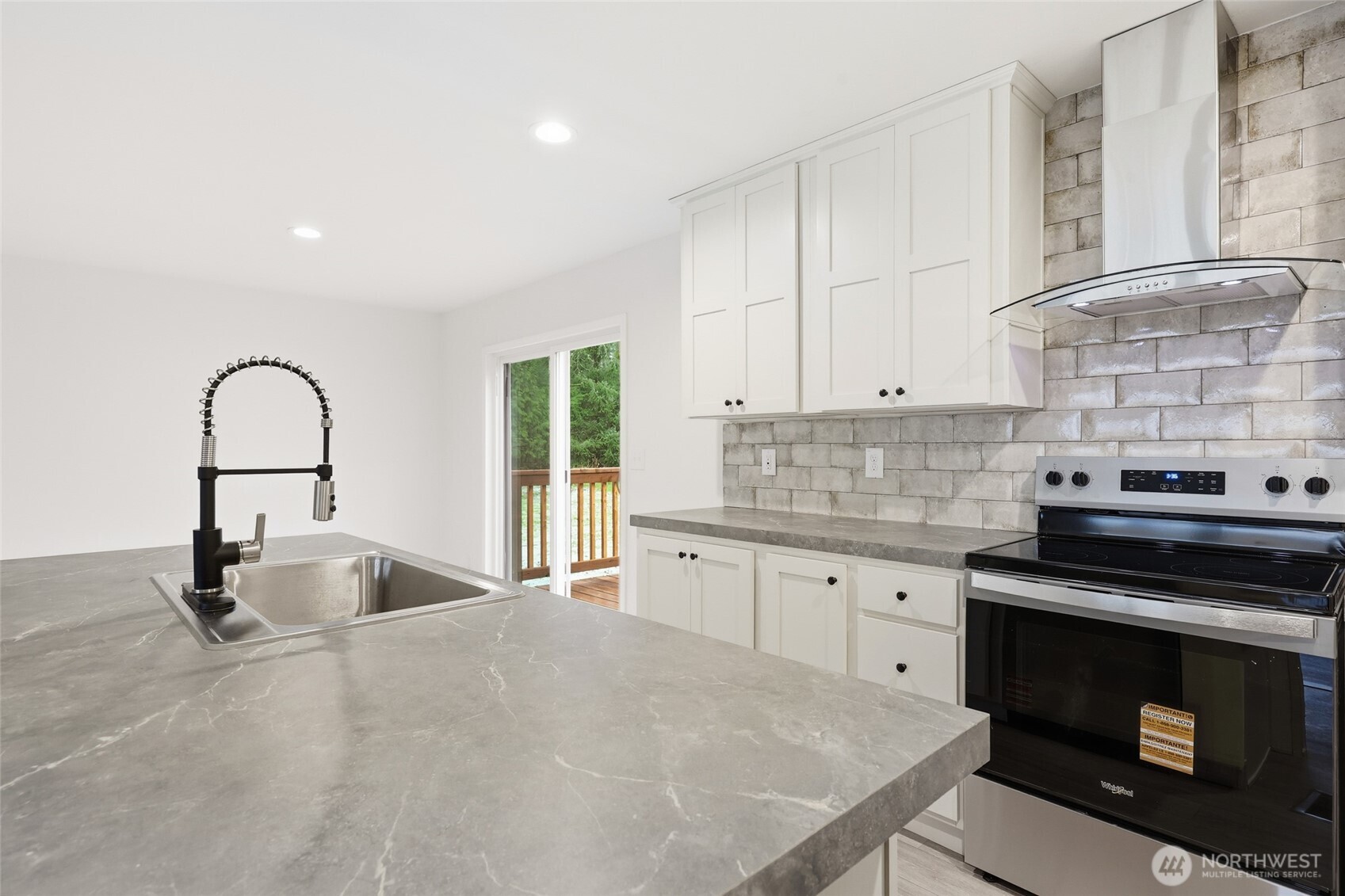 30 Porter Creek Road Elma, WA 98541 - Photo 12 of 33 a kitchen with granite countertop a stove and a sink