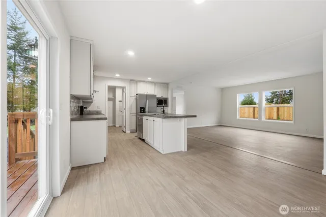 a kitchen with stainless steel appliances a refrigerator and a stove top oven