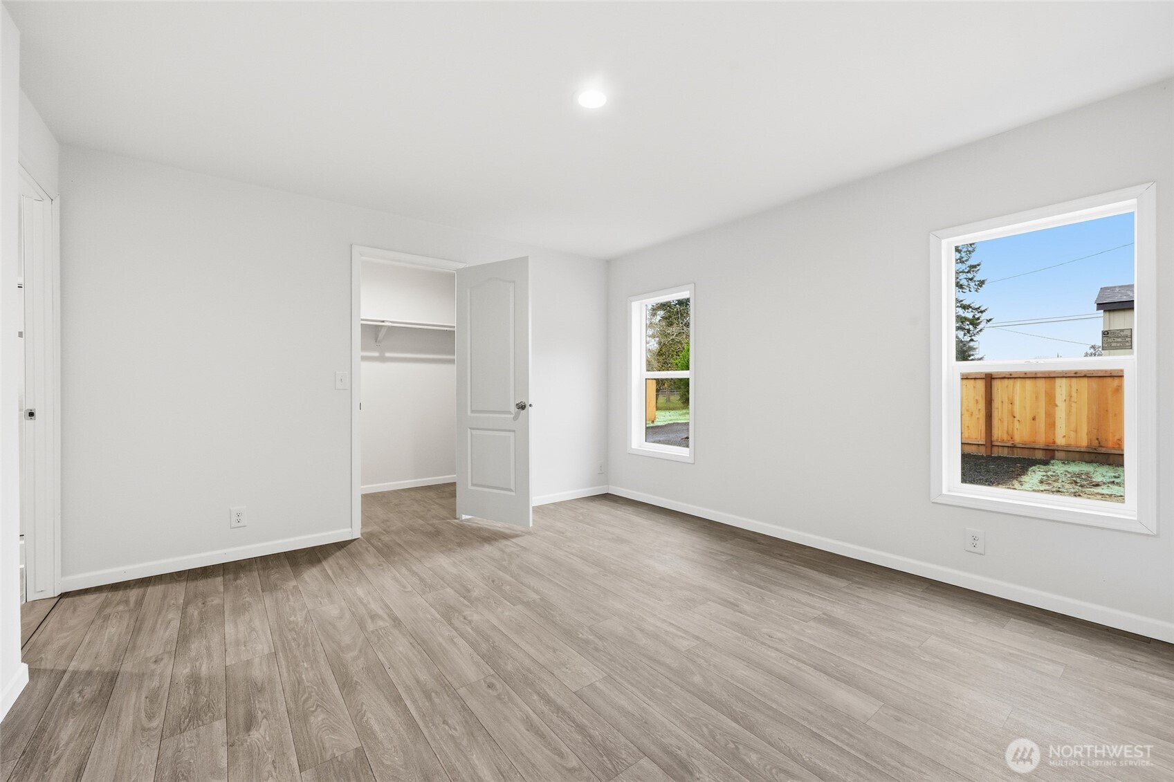 30 Porter Creek Road Elma, WA 98541 - Photo 16 of 33 an empty room with wooden floor and windows