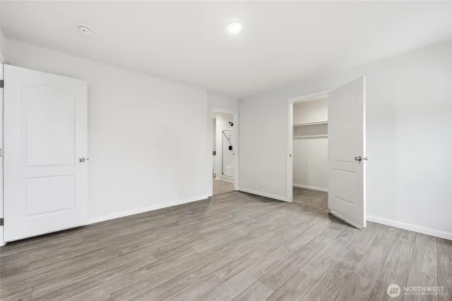 a view of hallway with wooden floor
