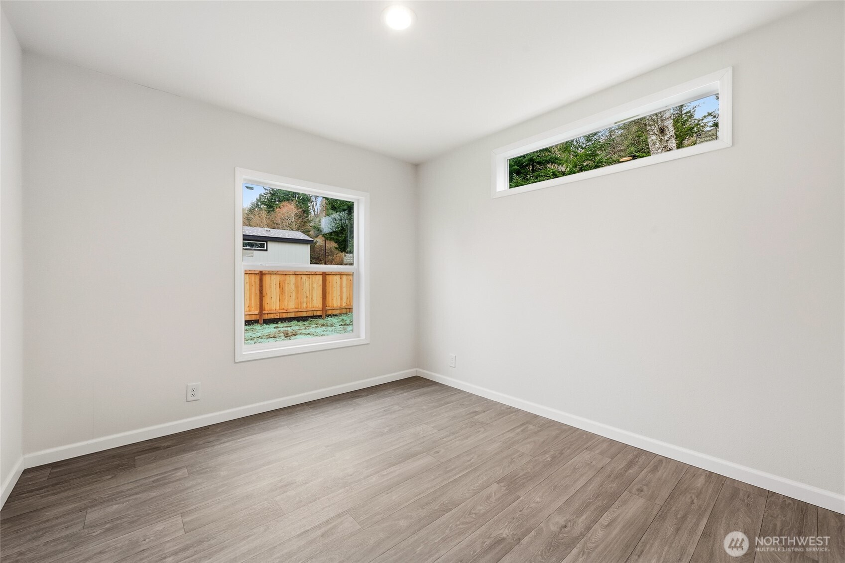 30 Porter Creek Road Elma, WA 98541 - Photo 26 of 33 an empty room with wooden floor and window