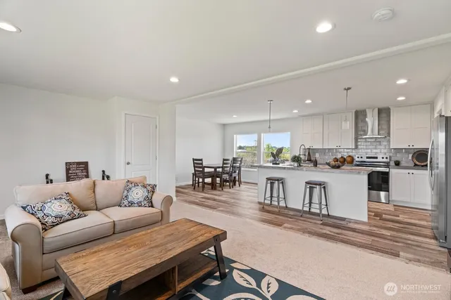 a living room with stainless steel appliances kitchen island granite countertop furniture and kitchen view