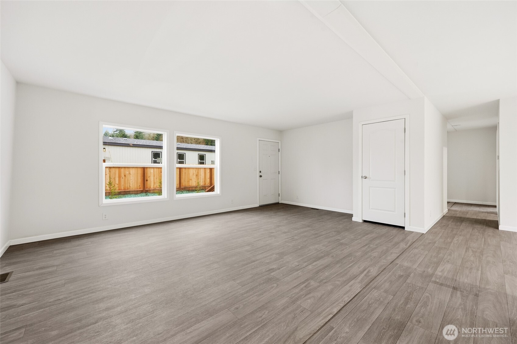 30 Porter Creek Road Elma, WA 98541 - Photo 8 of 33 an empty room with wooden floor and windows