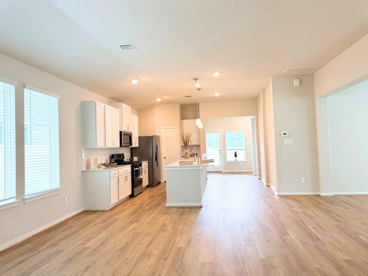 16246 Parish Pointe Court Conroe, TX 77302 - Photo 7 of 32 a view of a kitchen with a sink a counter top space and stainless steel appliances