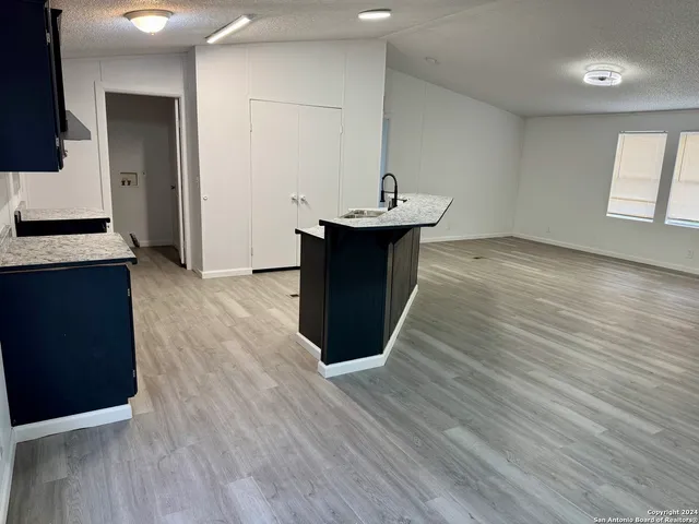 a kitchen with stainless steel appliances wooden floors and wooden cabinets