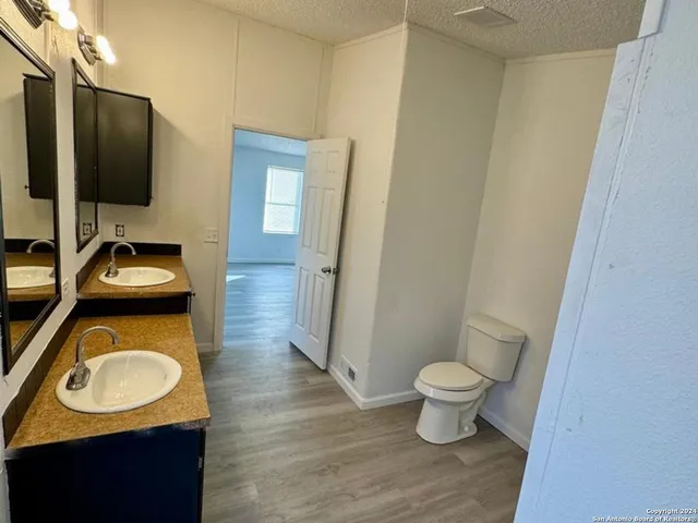 a bathroom with a toilet sink and mirror