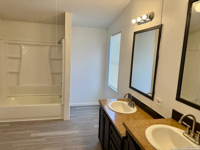 a bathroom with a sink double vanity and a mirror