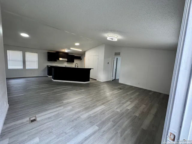 an empty room with wooden floor